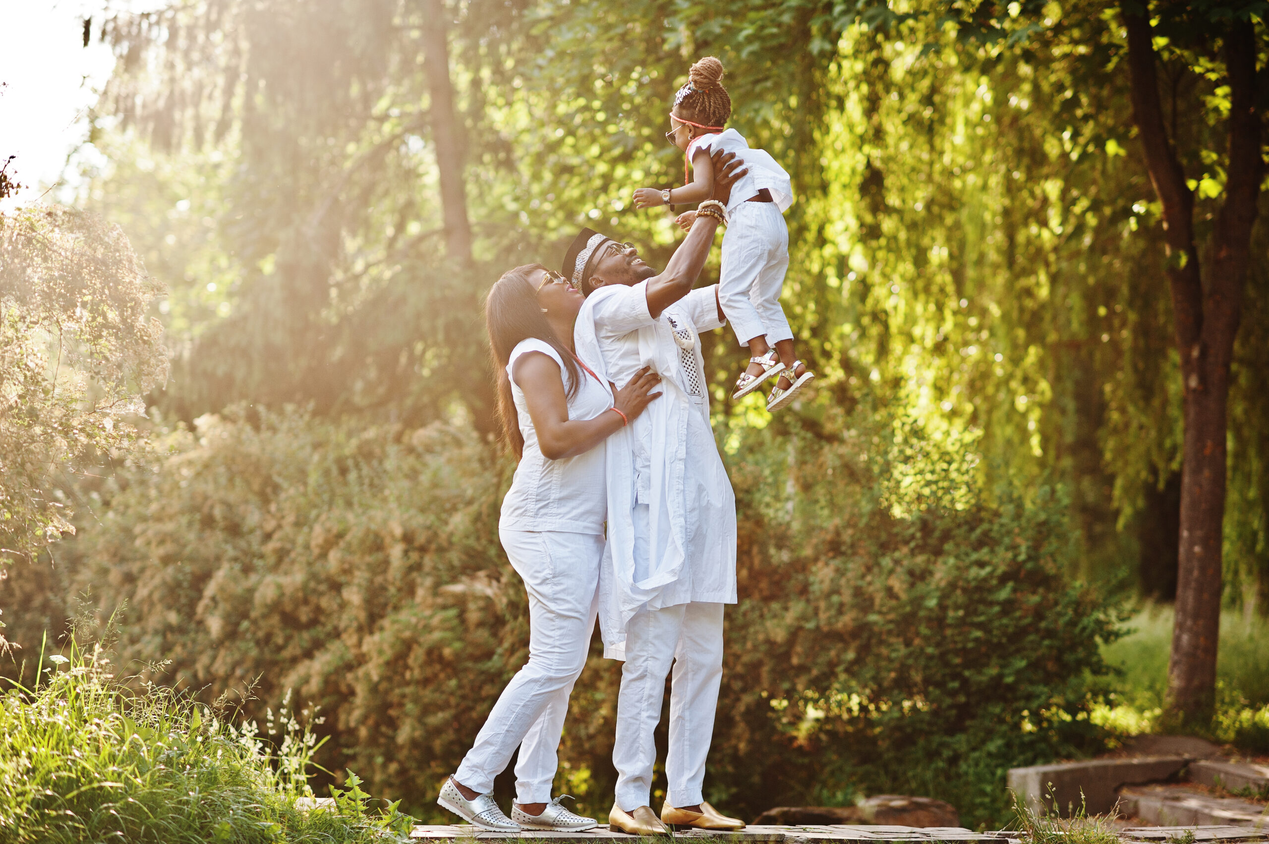 African american rich family having fun on sunset. Father throws daughter on his hands