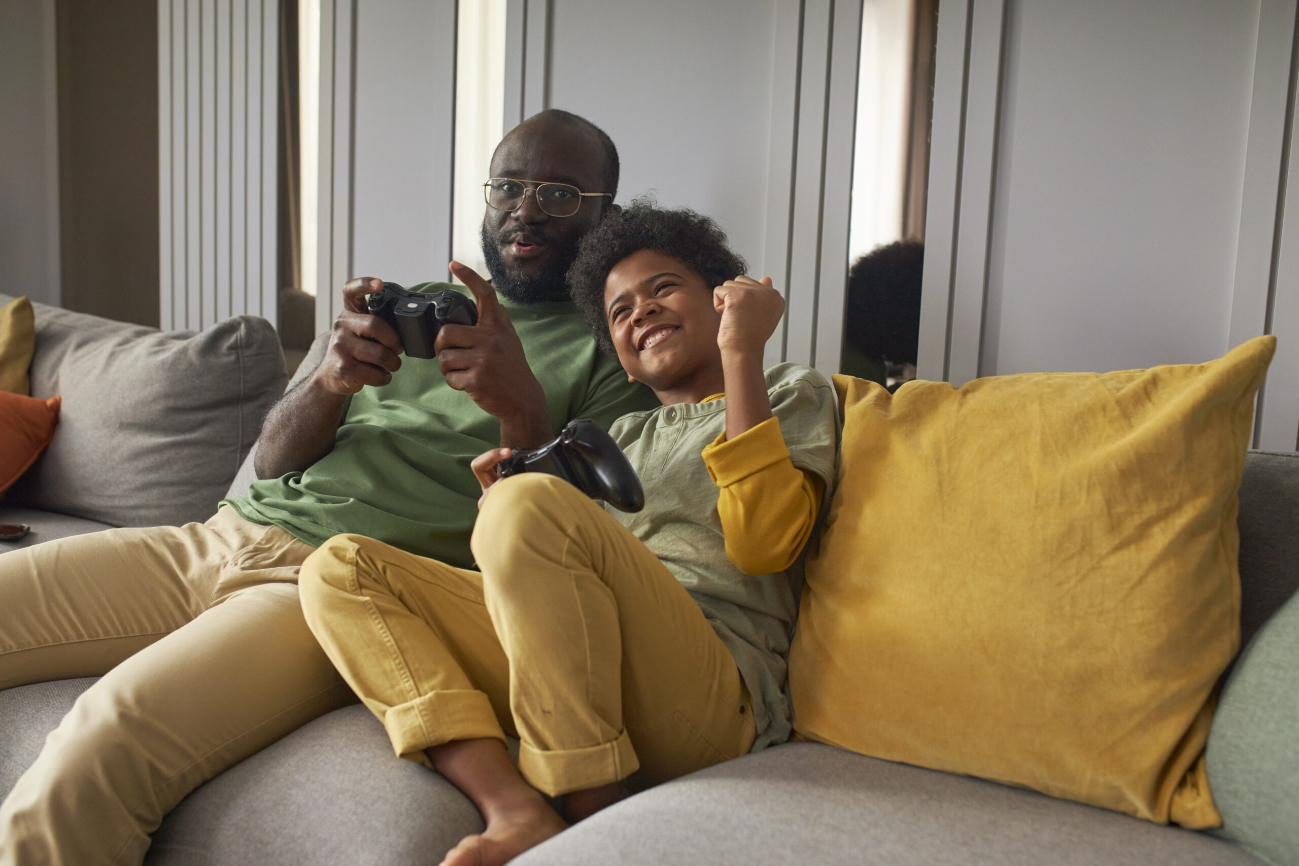 medium-shot-man-kid-playing-video-games